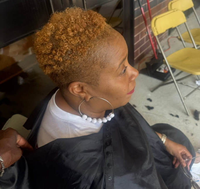 Client with styled natural curls and tapered sides